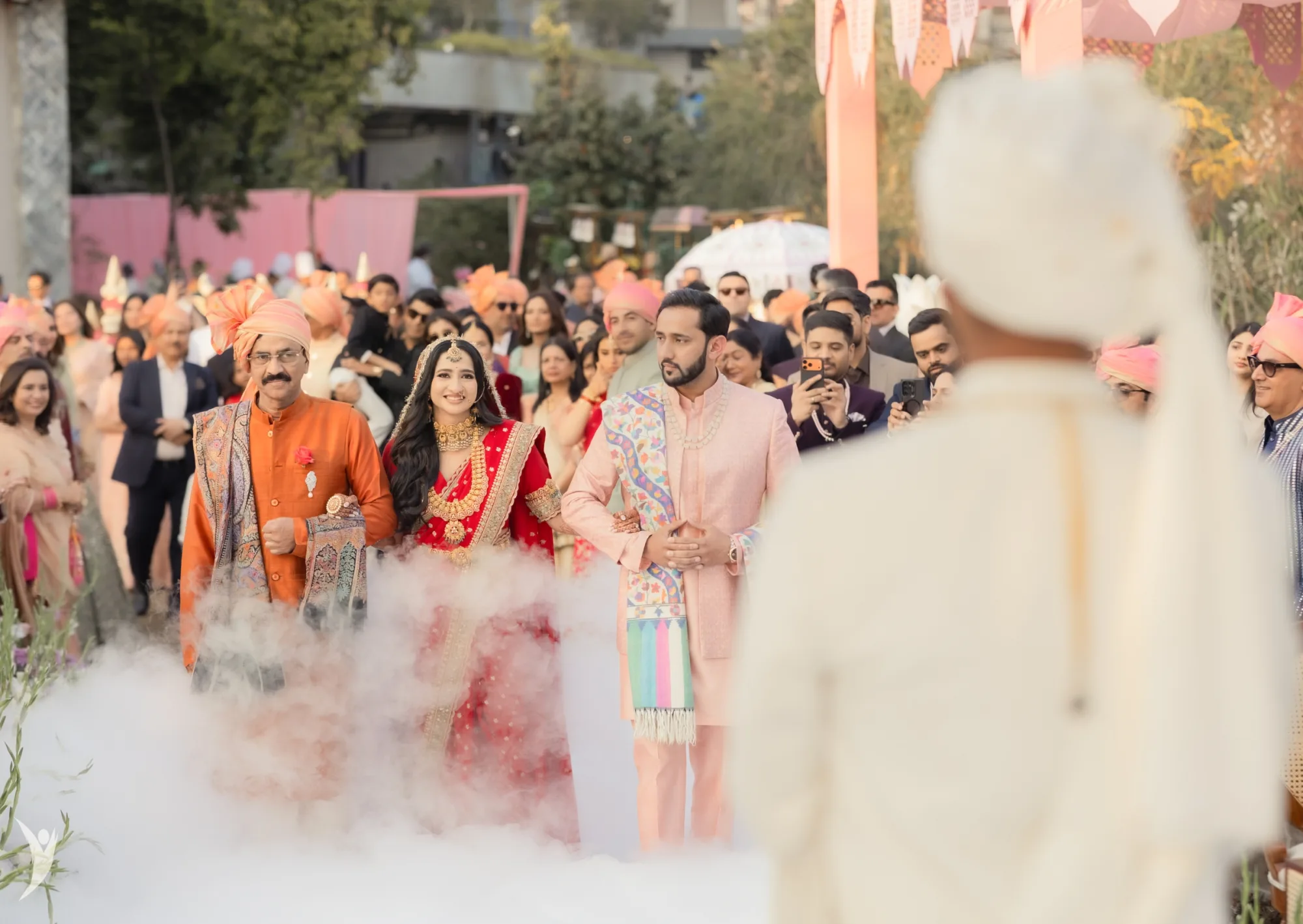 A bride’s entrance seen past the groom — documentary wedding photographer India