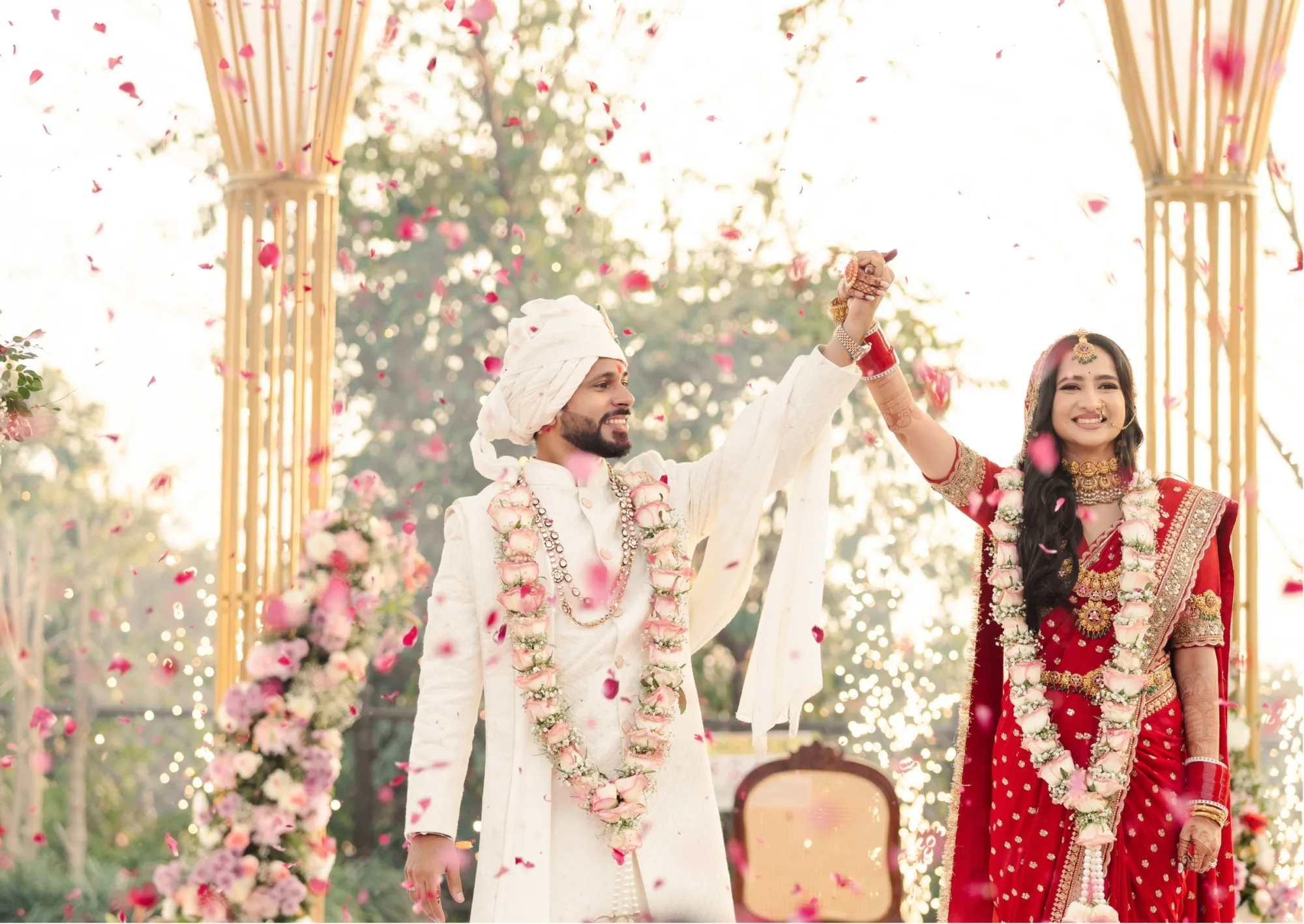 A married couple under a shower of petals — documentary wedding photographer India